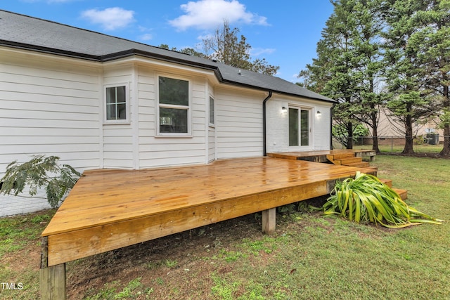 wooden deck featuring a lawn