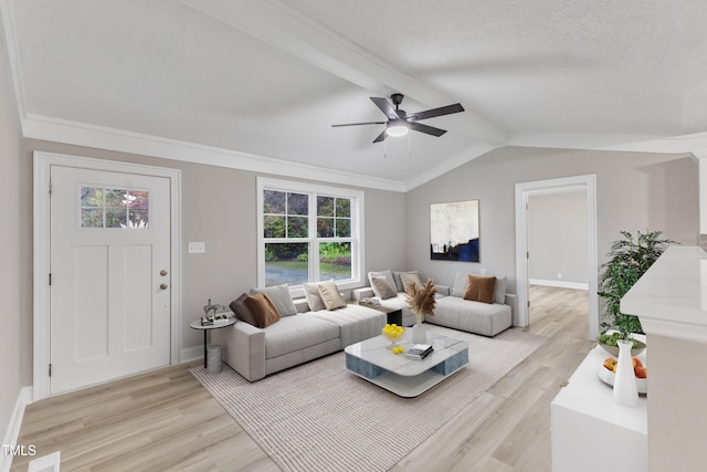 living room featuring plenty of natural light, light hardwood / wood-style floors, and vaulted ceiling with beams