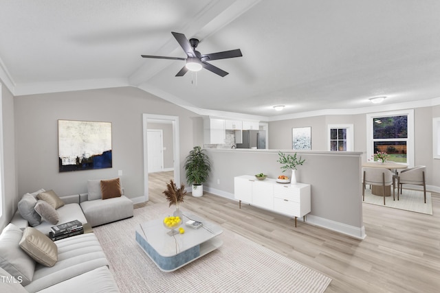 living room with lofted ceiling, crown molding, light hardwood / wood-style flooring, and ceiling fan