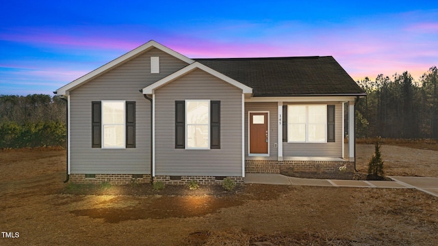 view of front of home featuring roof with shingles and crawl space