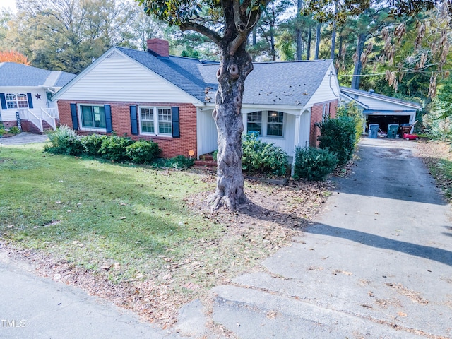 single story home with brick siding, a shingled roof, a front lawn, a chimney, and driveway