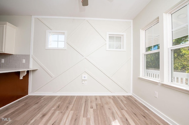 empty room featuring light hardwood / wood-style floors, plenty of natural light, and ceiling fan