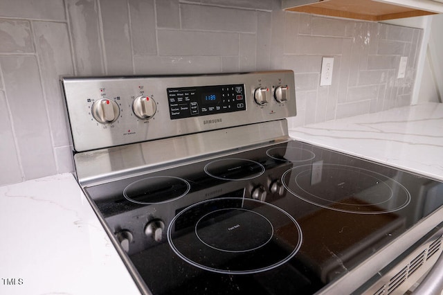 room details with stainless steel electric range oven and tasteful backsplash