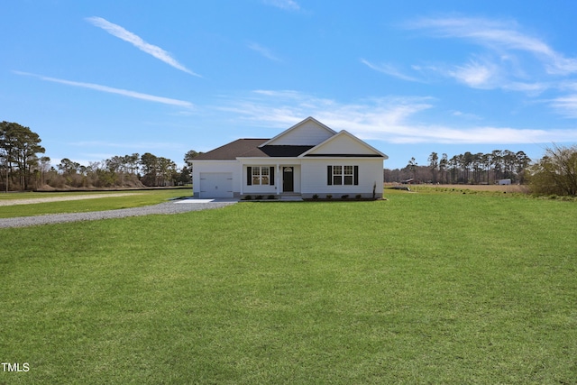 view of front of house with a front yard, an attached garage, and driveway