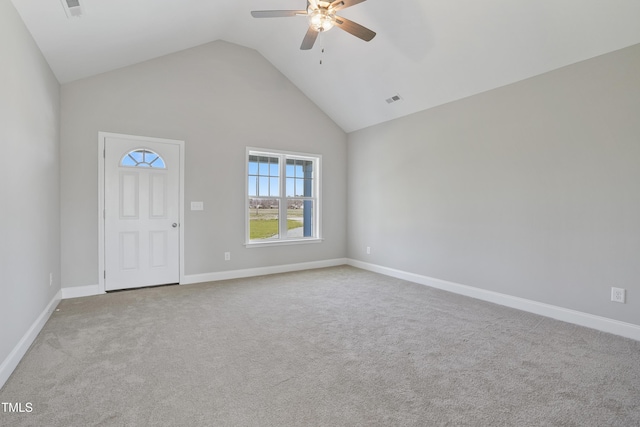 spare room featuring carpet, baseboards, visible vents, high vaulted ceiling, and ceiling fan