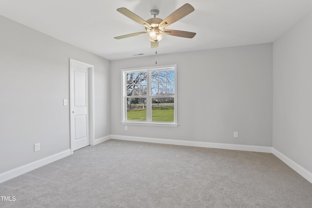 spare room featuring visible vents, baseboards, carpet floors, and ceiling fan