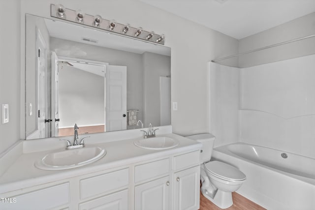 full bathroom with shower / bath combination, vanity, toilet, and wood-type flooring