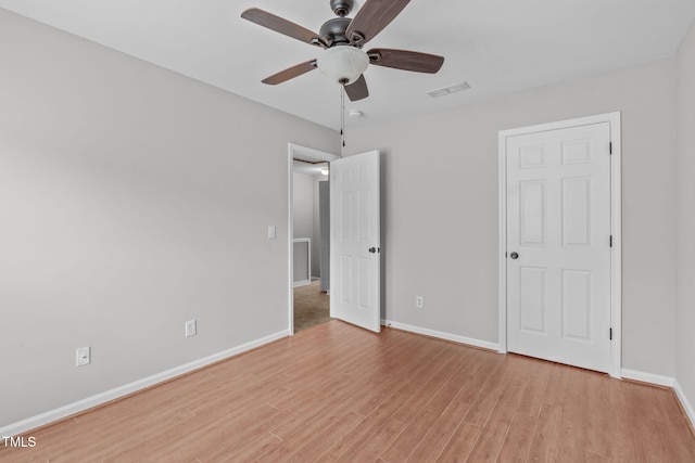 unfurnished bedroom featuring a ceiling fan, light wood-type flooring, visible vents, and baseboards