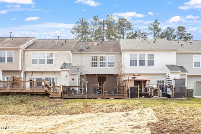 rear view of house featuring a gazebo, a yard, and a wooden deck