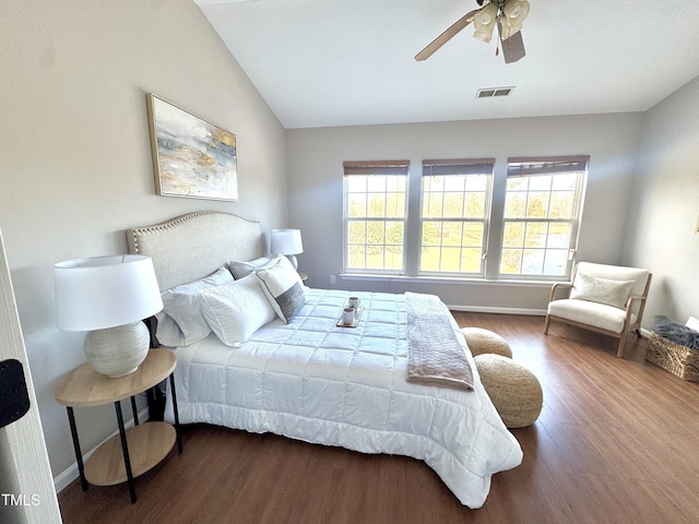 bedroom with wood finished floors, a ceiling fan, visible vents, vaulted ceiling, and baseboards