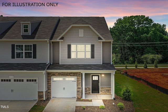 view of front of property featuring a lawn and a garage