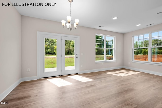 unfurnished dining area featuring an inviting chandelier, light hardwood / wood-style flooring, and plenty of natural light