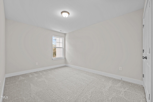 spare room with light colored carpet