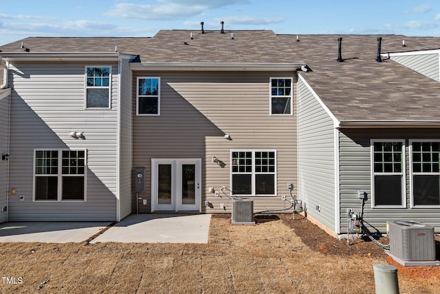 rear view of house featuring french doors, a yard, central AC unit, and a patio area