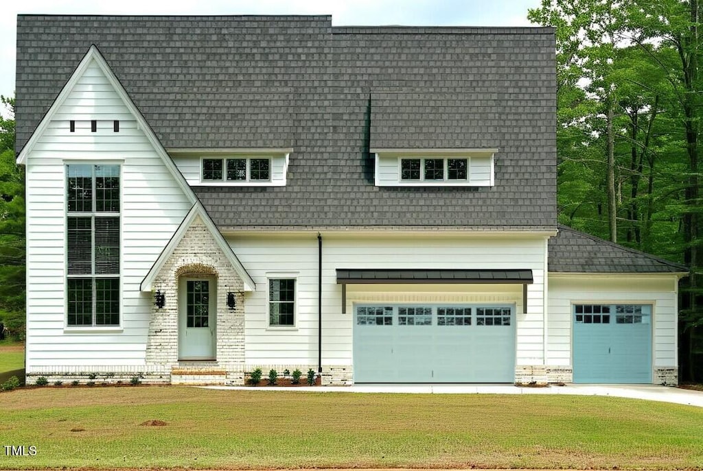 view of front of house with a garage and a front lawn