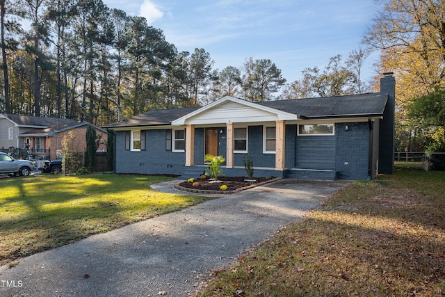 ranch-style home with a front yard and a porch