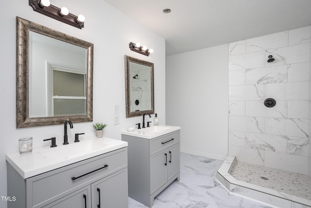 bathroom with a tile shower and vanity