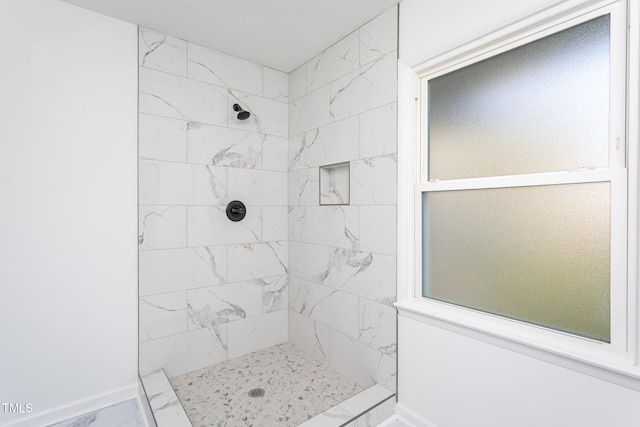 bathroom featuring tiled shower