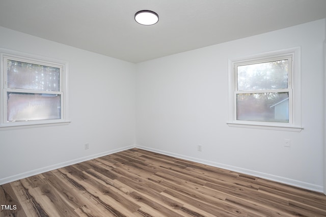 unfurnished room featuring hardwood / wood-style floors