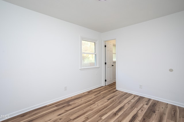 spare room featuring light hardwood / wood-style flooring