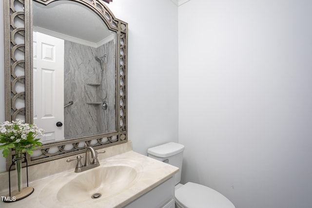 bathroom with vanity, toilet, and crown molding