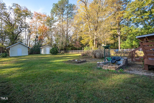 view of yard featuring a storage unit and an outdoor fire pit