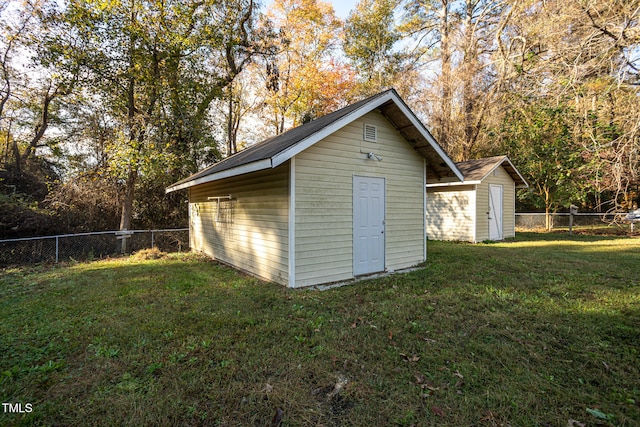 view of outbuilding featuring a yard