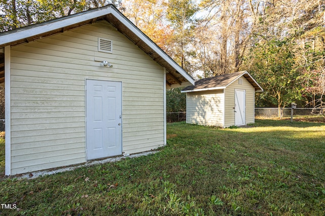 view of outbuilding with a lawn