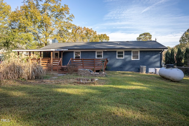 back of property featuring a deck, a lawn, and central air condition unit