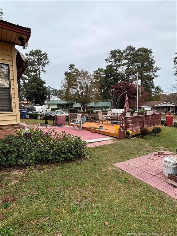 view of yard featuring a patio area and a deck