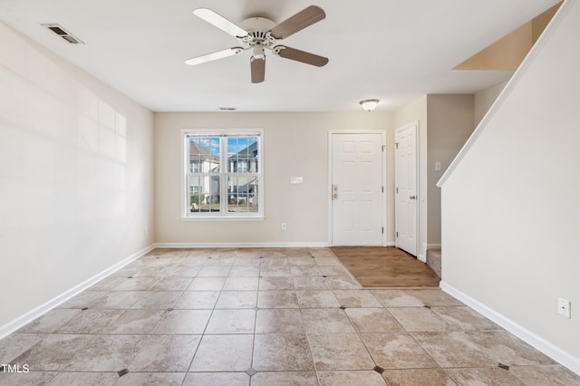 interior space with ceiling fan