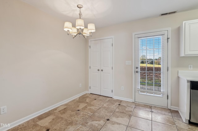 unfurnished dining area featuring an inviting chandelier