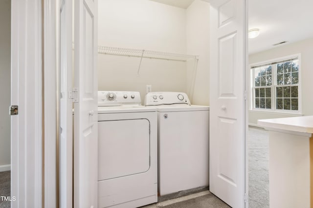 clothes washing area featuring carpet flooring and washing machine and dryer