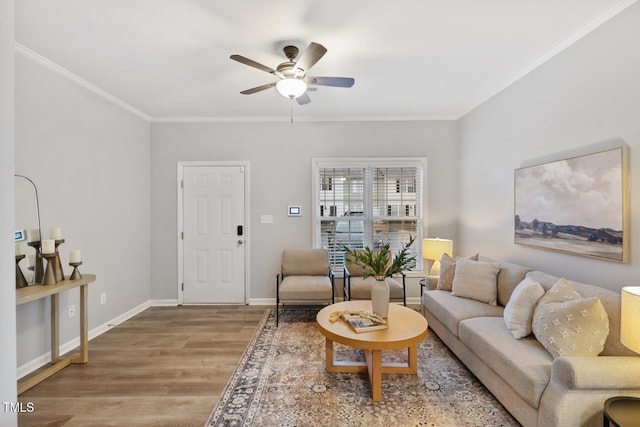 living room with hardwood / wood-style flooring, ceiling fan, and ornamental molding