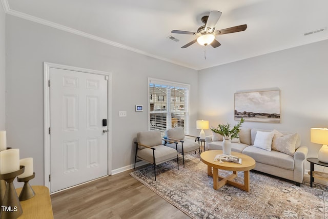 living room with crown molding, ceiling fan, and hardwood / wood-style flooring