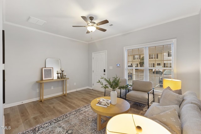 living room with ceiling fan, hardwood / wood-style floors, and ornamental molding