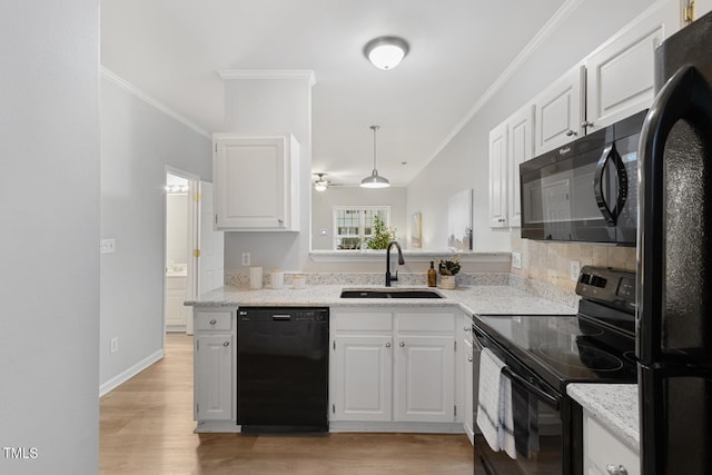 kitchen featuring black appliances, white cabinetry, and sink