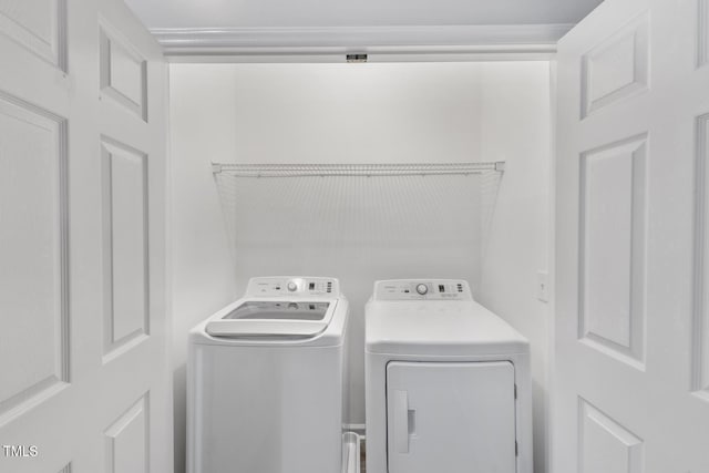 clothes washing area with separate washer and dryer