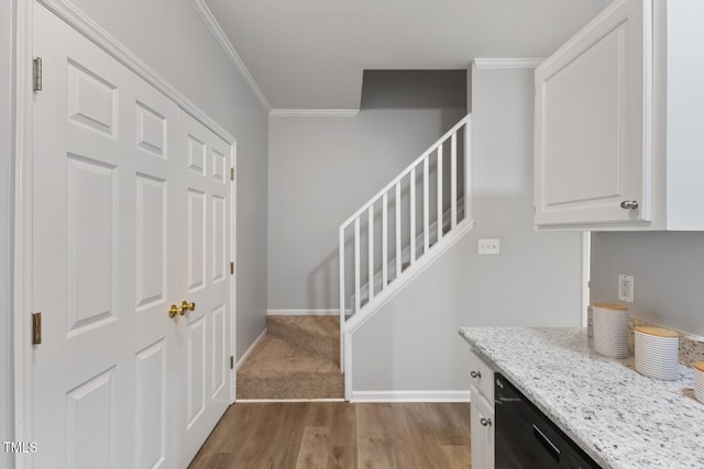 foyer entrance featuring light wood-type flooring and crown molding