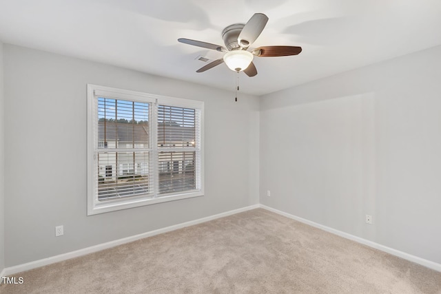 unfurnished room with ceiling fan and light colored carpet