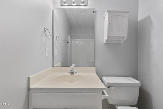 bathroom featuring a shower, vanity, and toilet