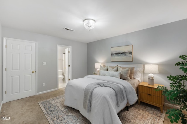 bedroom with carpet floors and ensuite bath