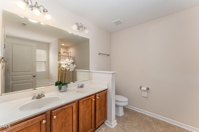 bathroom featuring toilet, vanity, a bath, and tile patterned flooring