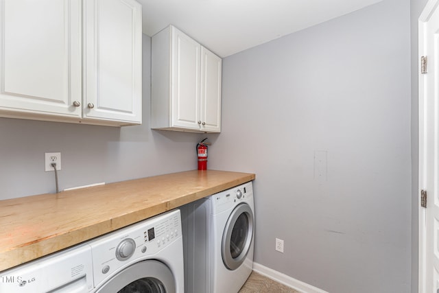 laundry room featuring cabinets and washing machine and dryer