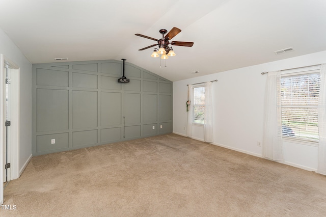 unfurnished bedroom featuring ceiling fan, light carpet, and lofted ceiling