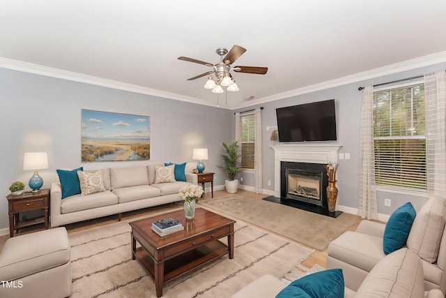 living room featuring ceiling fan and ornamental molding