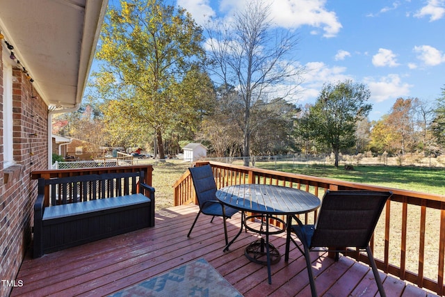 wooden terrace with a lawn and a shed