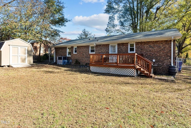 rear view of house with a storage unit, a yard, and a wooden deck