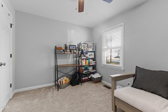 sitting room with ceiling fan and light carpet