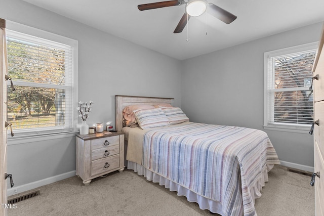 bedroom featuring ceiling fan and light carpet